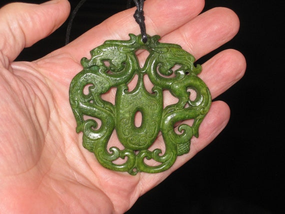 All natural hand carved two sided Jade dragon pendant.
