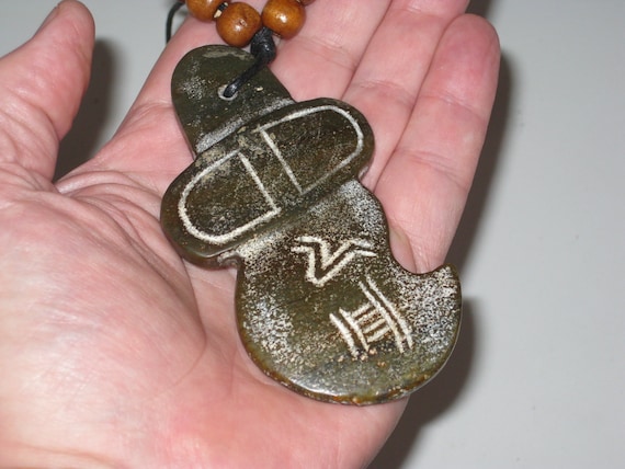 Primitive hand carved old jade stone amulet pendant, necklace is adjustable up to 32" long.