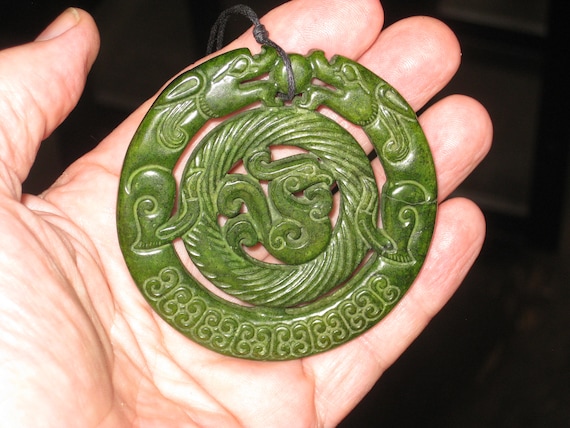All natural hand carved two sided Jade dragon pendant.