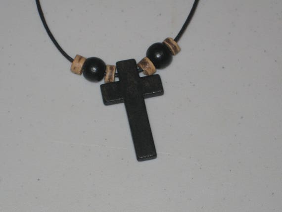 Hand carved cross with heishi wood beads.