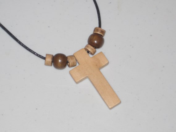 Hand carved cross adjustable necklace with heishi wood beads.