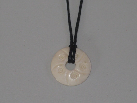 Hand carved bone pendant, with adjustable necklace.