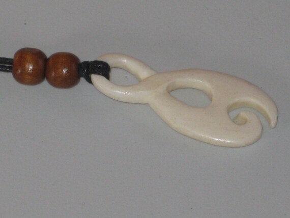 Hand carved bone pendant, with adjustable necklace.