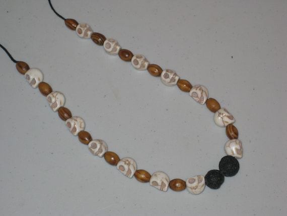 Howlite skulls, wood & lava bead necklace, adjustable and hand made.
