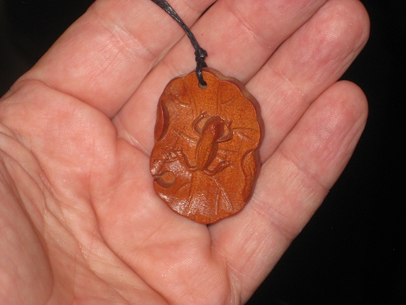 Hand carved rosewood frog on lily pad pendant, adjustable necklace.