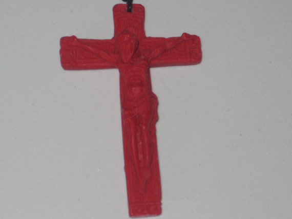 Hand carved red organic cinnabar cross pendant.