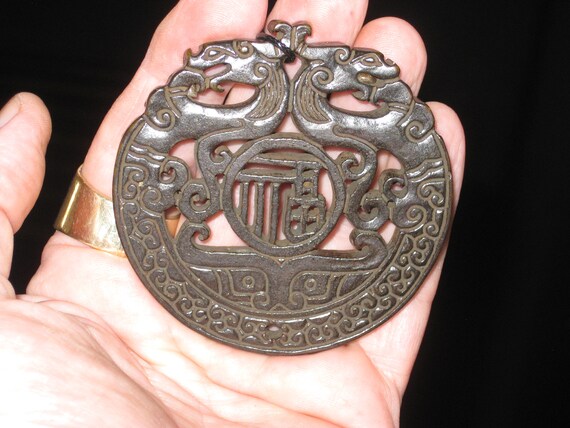 All natural hand carved two sided very old black Jade dragon pendant.