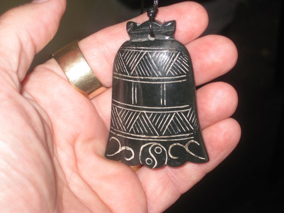 Very old hand carved two sided morning bell pendant, with adjustable necklace.