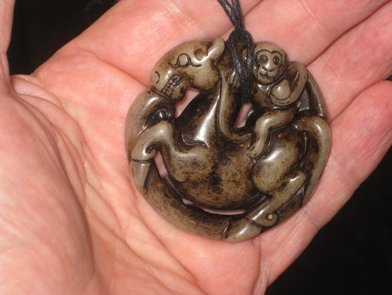 All natural hand carved two sided Jade monkey and horse pendant, with adjustable necklace.