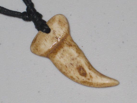 Dinosaur tooth, hand made out of buffalo bone.