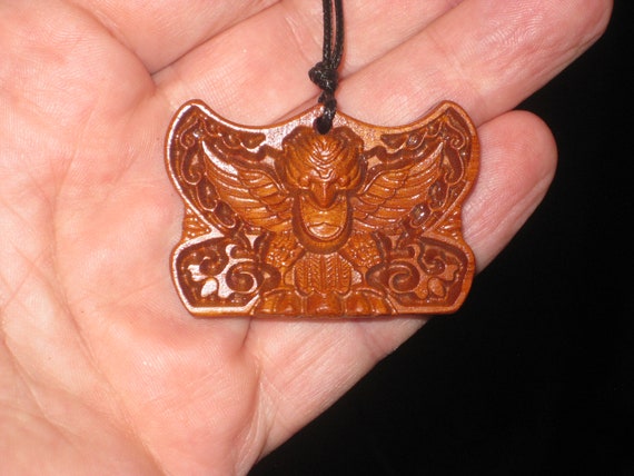 Hand carved rosewood monkey skull with eagle wings pendant, adjustable necklace.