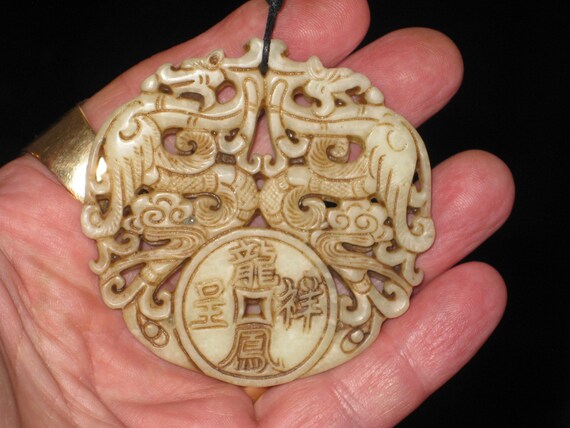 All natural jade hand carved two sided Phoenix pendant, with adjustable necklace.
