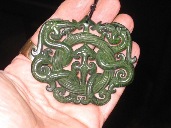 All natural jade hand carved two sided dragon pendant, with adjustable necklace.
