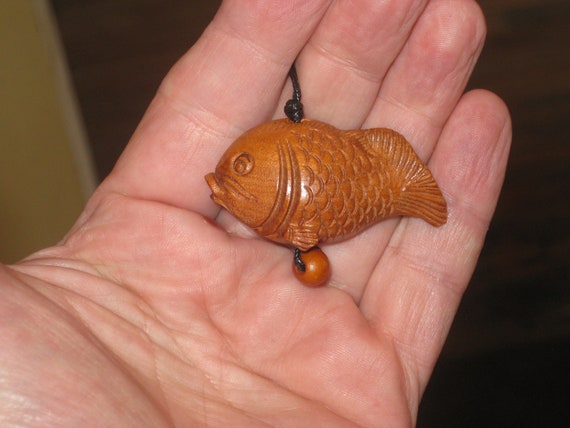 Hand carved rosewood fish pendant.