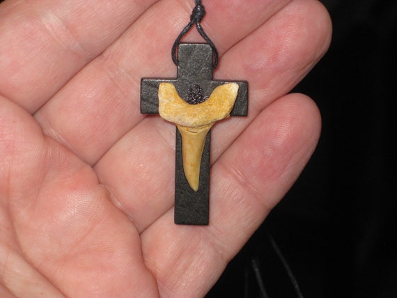 Hand carved wood cross pendant with fossilized shark tooth.