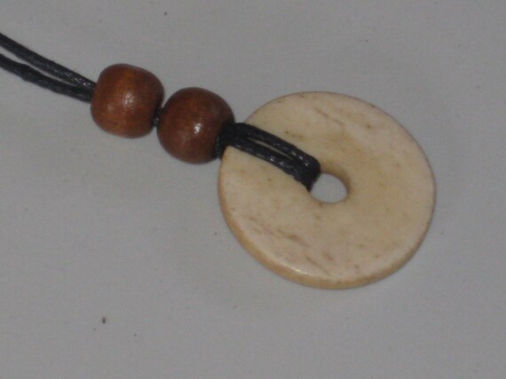 Hand carved bone pendant, with adjustable necklace.