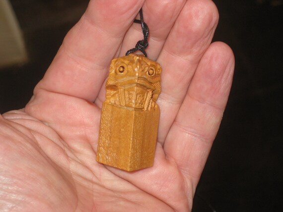 Hand carved rosewood feng shui wealth frog pendant.