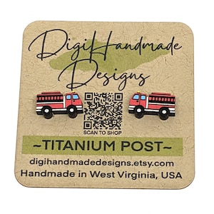 May include: A pair of red and black fire truck stud earrings on a tan card with the text "Digi Handmade Designs" and "-TITANIUM POST-". The card also includes a QR code and the Etsy shop URL.