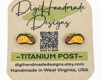 May include: A pair of wooden taco earrings with green lettuce, red meat, and yellow tortilla. The earrings are on a card that says "Digi Handmade Designs" and "Titanium Post".