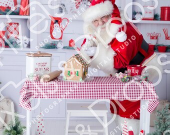 May include: Santa Claus in a red suit and hat, preparing a gingerbread house on a table covered with a red and white checkered tablecloth. The scene includes Christmas decorations and baking supplies. The text "Gingerbread Kisses & Christmas Wishes" is visible.