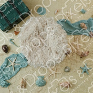 May include: A white faux fur backdrop with a blue and white fabric, seashells, starfish, and a small green wooden chest. This backdrop is perfect for newborn photography.