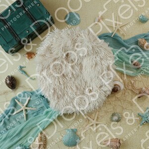 May include: A white faux fur rug with a blue and green fabric draped over it. The fabric has a net-like texture. There are seashells, starfish, and other ocean-themed decorations scattered on the rug and fabric.