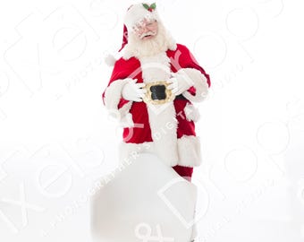 May include: Santa Claus in a red suit with white fur trim, a black belt, and a white beard, standing next to a white chair with wooden legs. He is wearing a red hat with a sprig of holly. The background is white.