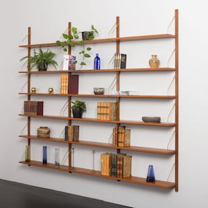 Reserved for Caroline18 shelves renovated modular teak wall unit in the style of Poul Cadovius, 1970s.