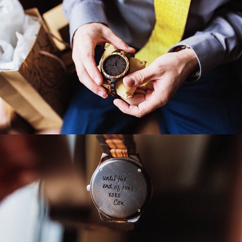 May include: A wooden wristwatch with a dark brown face and a light brown band. The back of the watch has a handwritten message that reads "until the end of time xoxo Con."