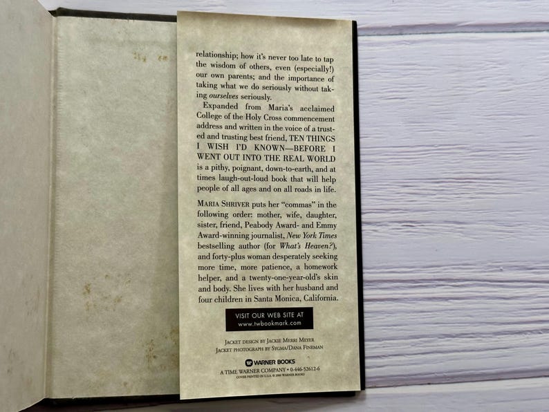 May include: Open book with a bookmark. The bookmark features text from the book "TEN THINGS I WISH I'D KNOWN - BEFORE I WENT OUT INTO THE REAL WORLD" by Maria Shriver. The book's cover is not visible.