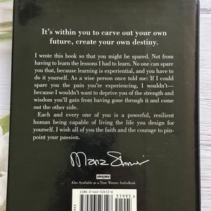 May include: A hardcover book with a dark cover featuring white text. The text includes the phrases "It's within you to carve out your own future, create your own destiny." The author's signature is visible.