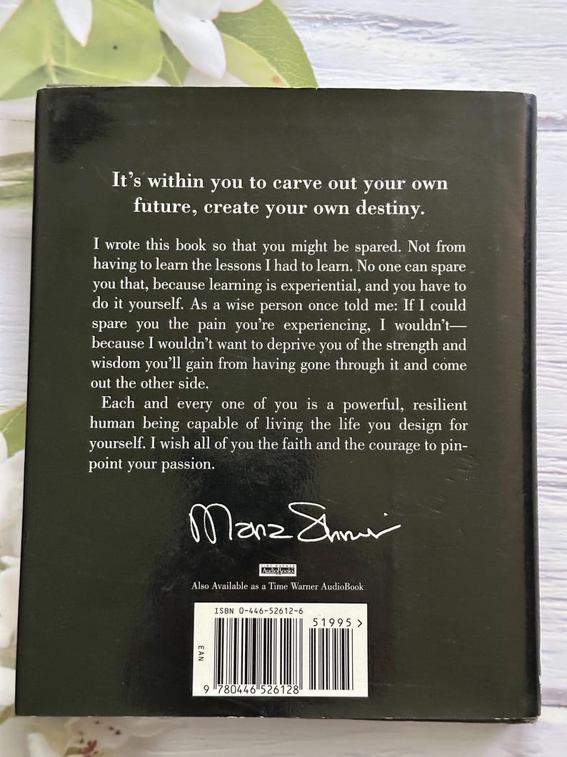 May include: A hardcover book with a dark cover featuring white text. The text includes the phrases "It's within you to carve out your own future, create your own destiny." The author's signature is visible.