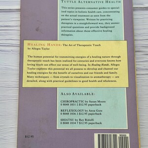 May include: A book titled "Healing Hands: The Art of Therapeutic Touch" by Allegra Taylor. The book is part of the "Tuttle Alternative Health" series, focusing on holistic health care. The cover is a light purple color with text in white and yellow.