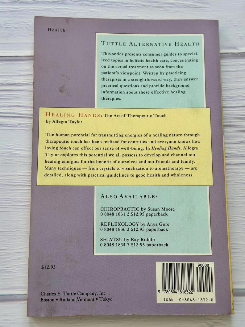 May include: A book titled "Healing Hands: The Art of Therapeutic Touch" by Allegra Taylor. The book is part of the "Tuttle Alternative Health" series, focusing on holistic health care. The cover is a light purple color with text in white and yellow.