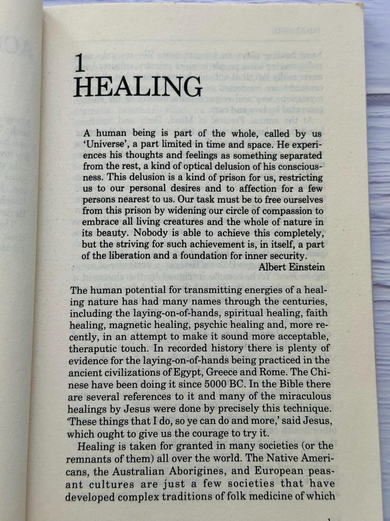 May include: Open book page with the title "HEALING" at the top. The text discusses the concept of healing, referencing historical practices and the words of Albert Einstein and Jesus. The page is from a book.