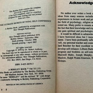 May include: Open book pages with text. The left page lists printing history, copyright information, and the ISBN of "The Ultimate Secrets of Total Self-Confidence" by Dr. Robert Anthony. The right page contains acknowledgements.