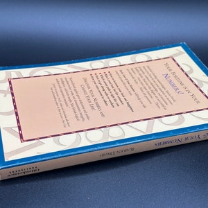 May include: A blue book titled "Your Fortune is in Your Numbers!" by Karen David. The back cover features a design of numbers and the text "Discover Your Numbers and Change Your Life!"
