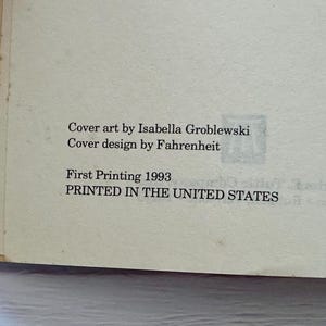 May include: A close-up of a book page with text. The text reads "Cover art by Isabella Groblewski, Cover design by Fahrenheit, First Printing 1993, PRINTED IN THE UNITED STATES."