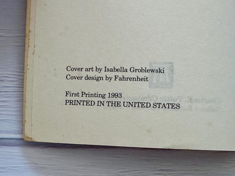 May include: A close-up of a book page with text. The text reads "Cover art by Isabella Groblewski, Cover design by Fahrenheit, First Printing 1993, PRINTED IN THE UNITED STATES."