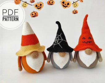 May include: Three crocheted Halloween gnomes with different hats. One gnome wears a candy corn hat, another wears a black witch hat with a spiderweb, and the third wears an orange hat with a jack-o'-lantern face.