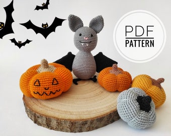 May include: Crochet pattern PDF for making Halloween amigurumi toys. The pattern includes instructions for making a gray bat, an orange pumpkin, and a gray pumpkin.  PDF PATTERN is written in white text on a white circle.