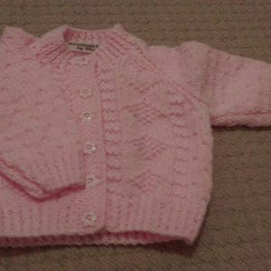 Pretty pink cardigan with diamond pattern and flower buttons image 1