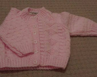Pretty pink cardigan with diamond pattern and flower buttons