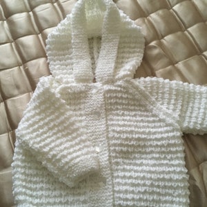 A Cosy Knitted Jacket with Hood and Pompom