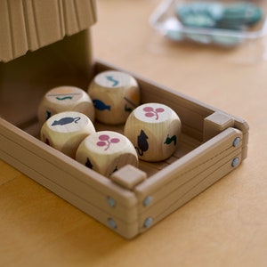 Close up of food resource dice in a 3D printed dice tower from the board game Wingspan in