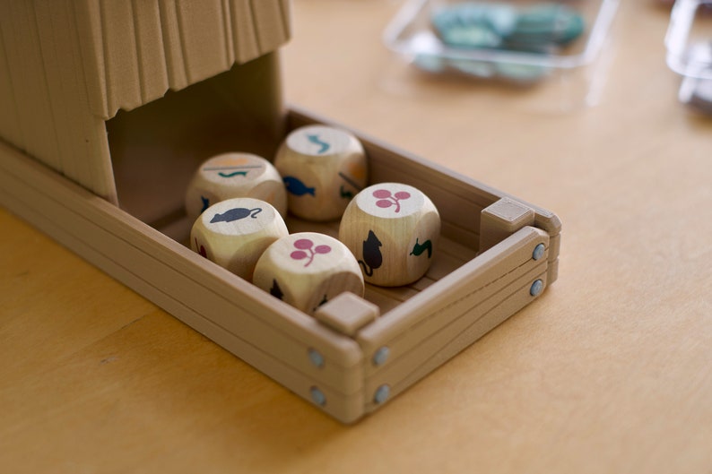 Close up of food resource dice in a 3D printed dice tower from the board game Wingspan in