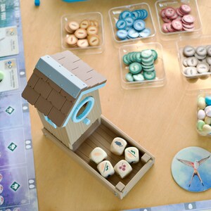 Overhead view of 3D printed dice tower being used in the board game Wingspan.