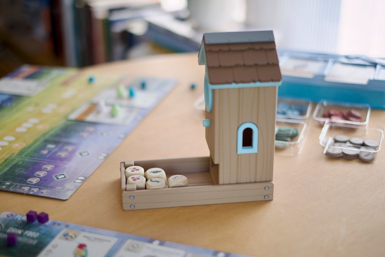 Side view of a Wingspan board game dice tower