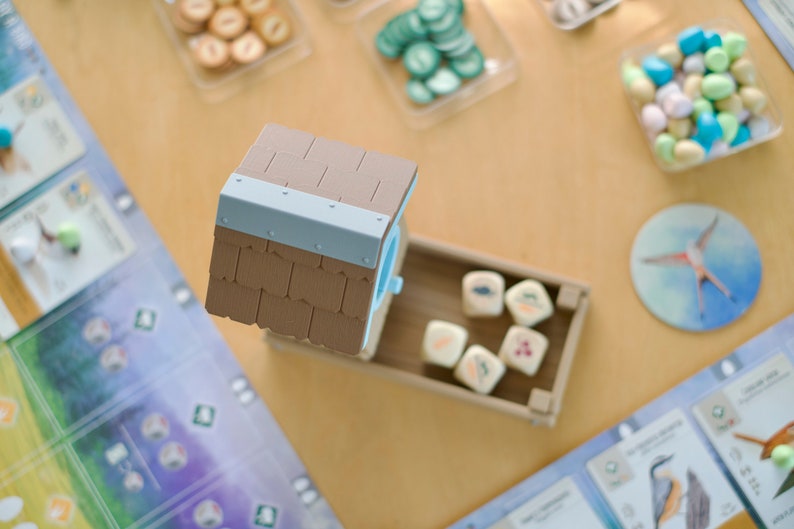 Overhead view of 3D printed dice tower being used in the board game Wingspan.
