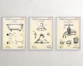 May include: Set of three framed patent prints featuring vintage bathroom fixtures. The prints showcase detailed technical drawings of a bathtub, showerhead, and faucet, all against a cream-colored background. Each print is labeled with the "UNITED STATES PATENT OFFICE".